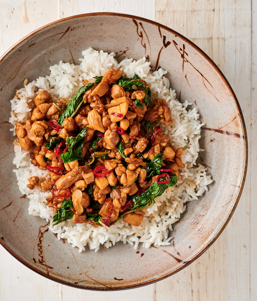 Bowl of Thai basil chicken on a bed of rice.