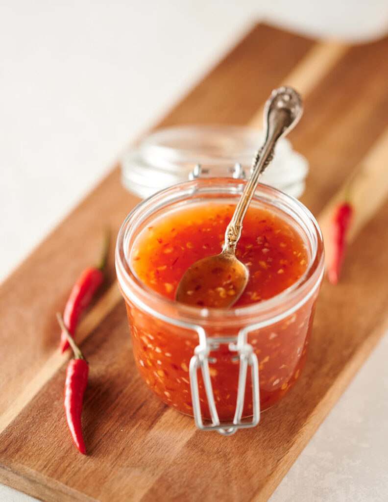 Spoon in a mason jar full of Thai sweet chili sauce
