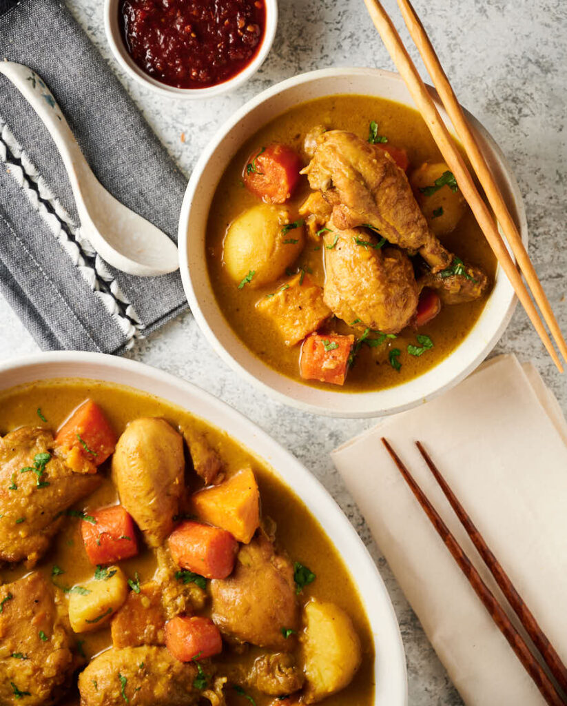 Bowl of Vietnamese chicken curry with chopsticks from above.