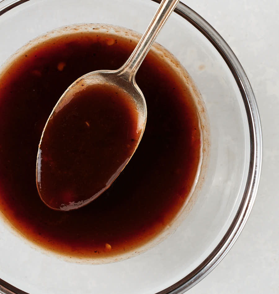 Bowl of pad Thai sauce with spoon from above.