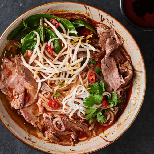 Bowl of spicy beef noodle soup from above.