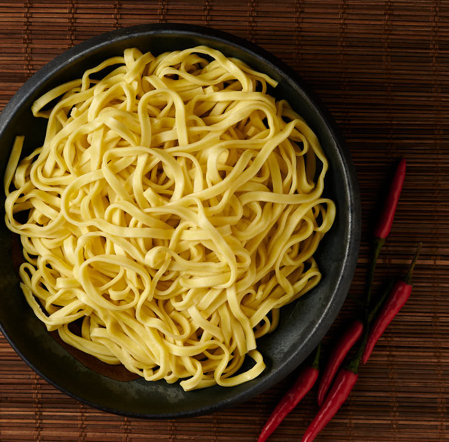 Bowl of cooked lo mein noodles from above.