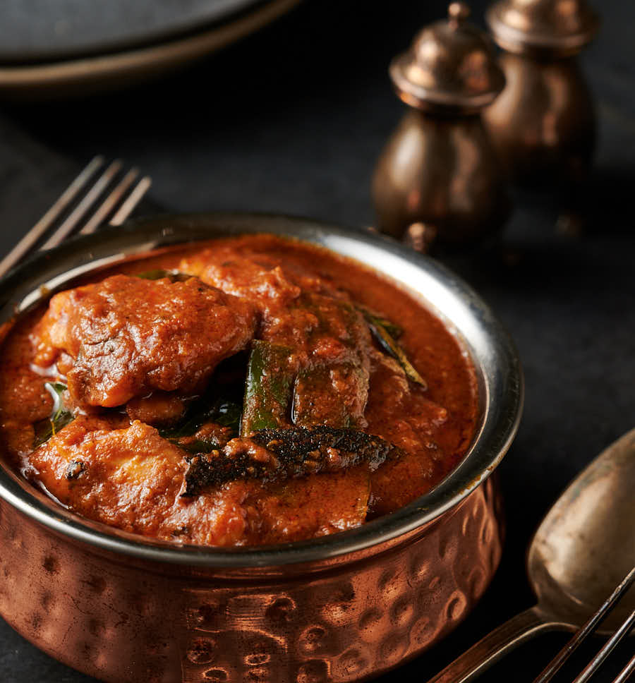 Ceylon chicken in a Indian style hammered copper bowl from the front.