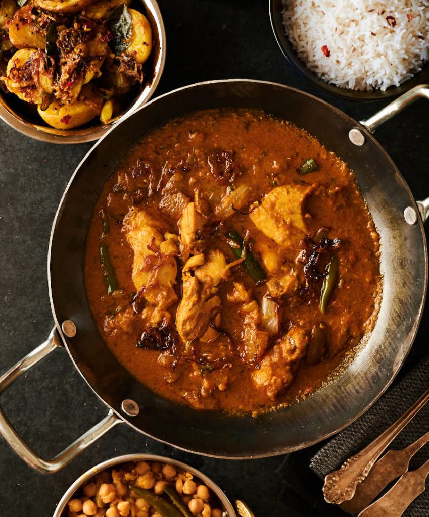 Indian hotel style chicken dopiaza with side dishes.