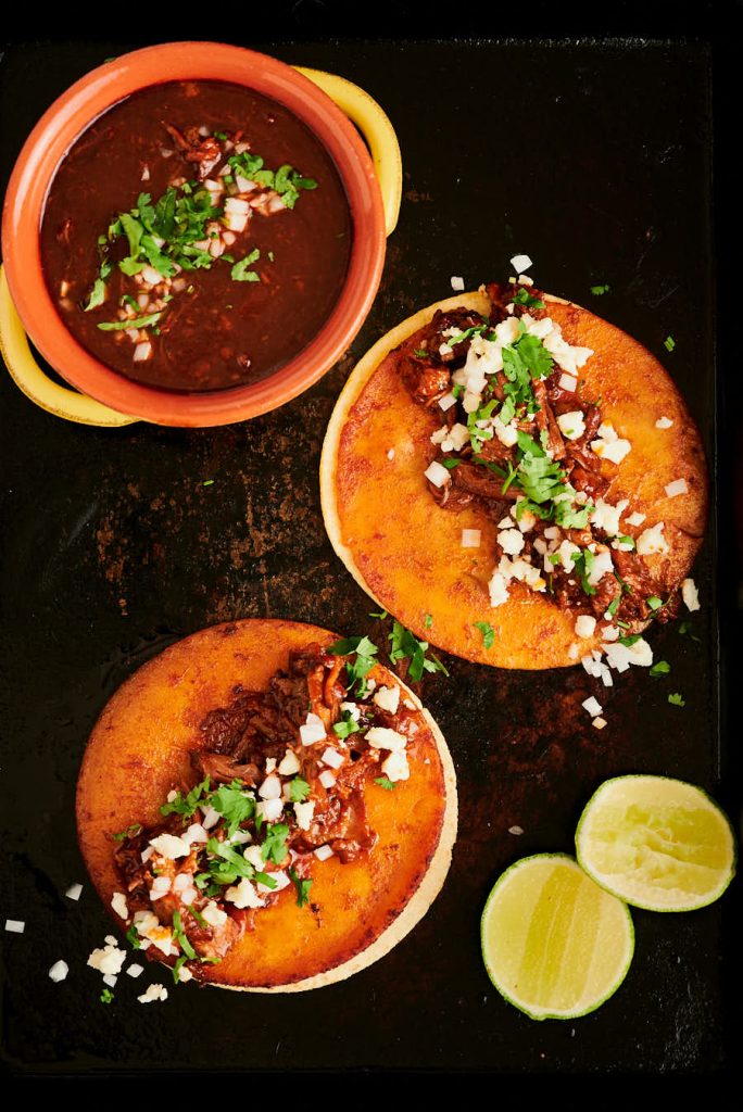 Birria de res tacos and consommé from above.