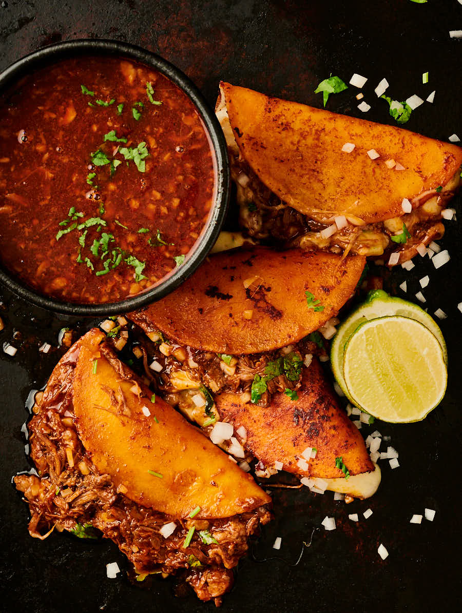 Birria tacos and consomé from above.