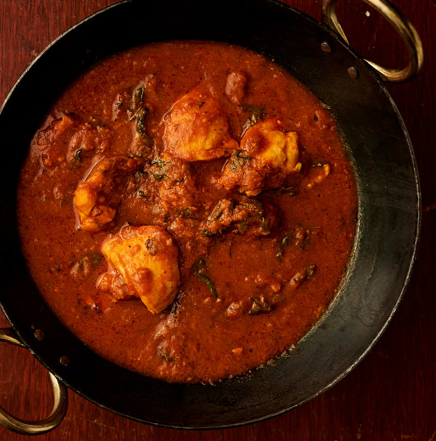 Methi chicken in a kadai from above.