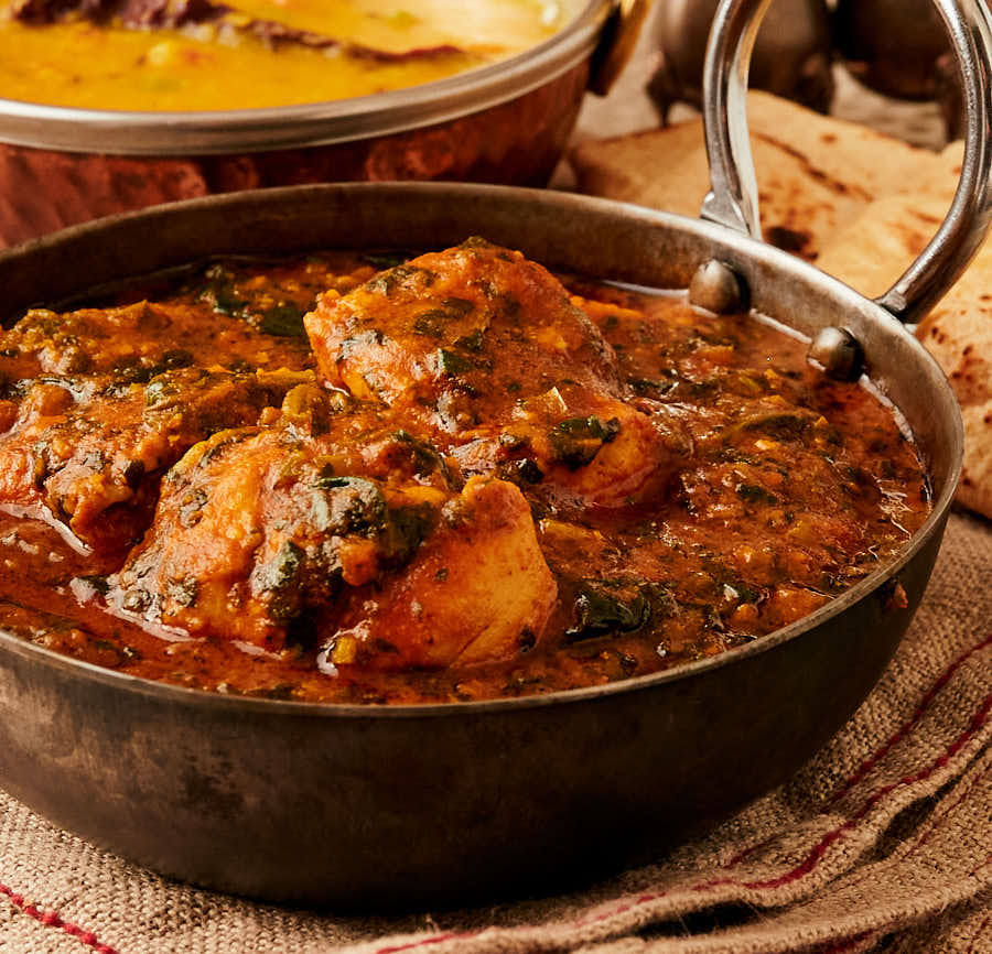 Bowl of palak chicken from the front.