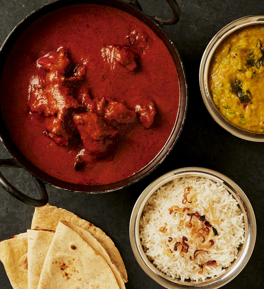 Table scene - chicken tikka masala, dal, rice and chapatis.