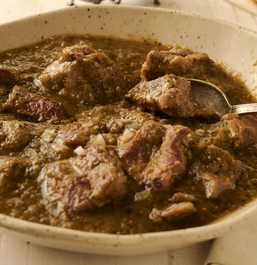 Close-up of a spoon in a bowl of chili verde