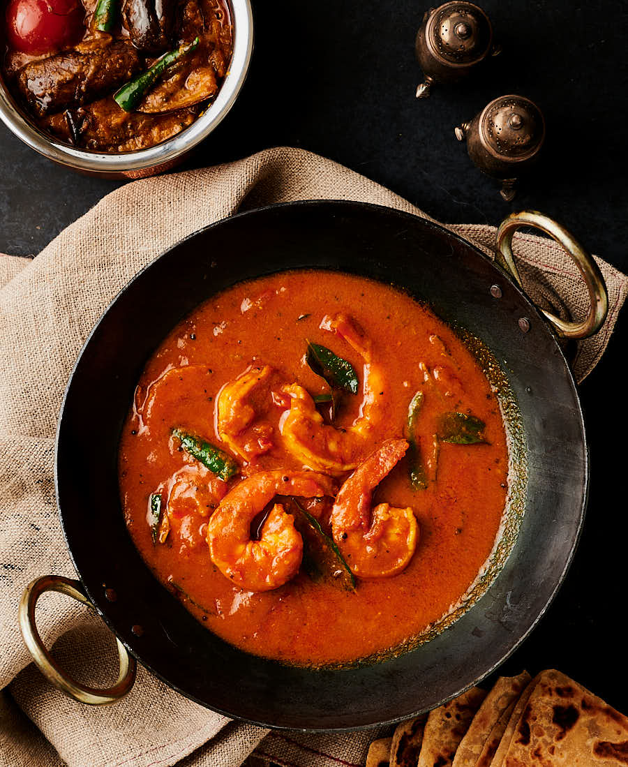 Table scene with prawn curry and eggplant curry from above.