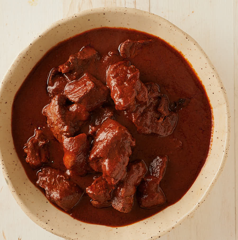 Carne adovada in a ceramic bowl from above.