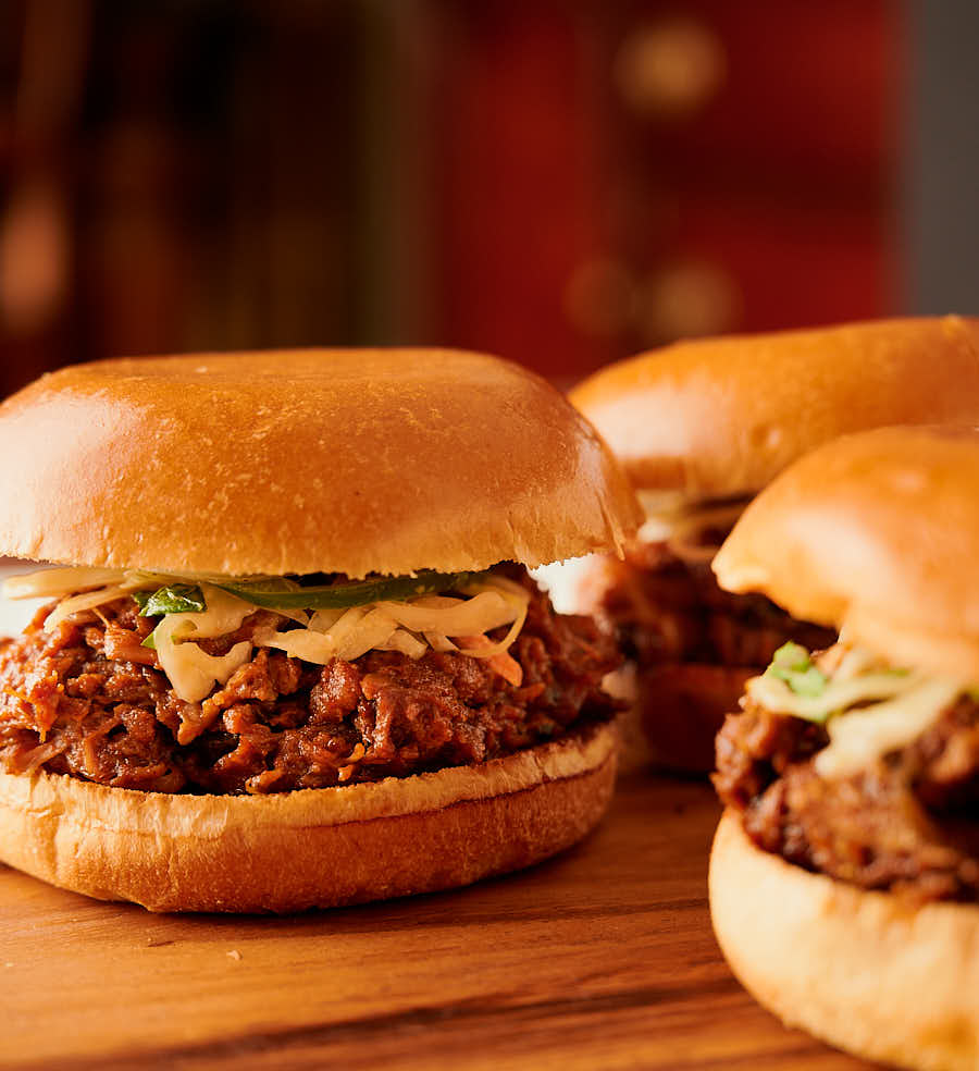 Vindaloo pulled pork sandwich on a cutting board