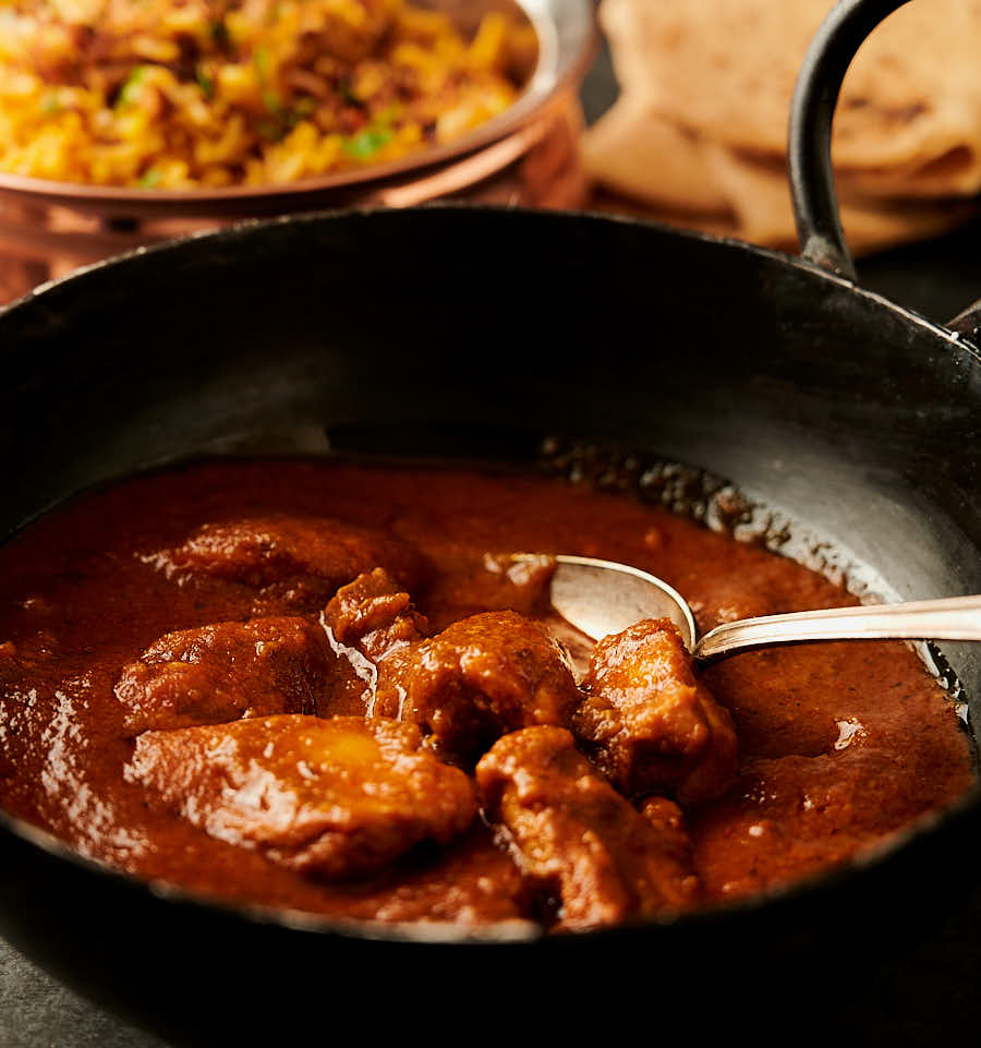 Chicken pathia in a bowl from the front.