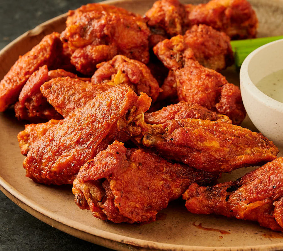 A pile of crispy vindaloo chicken wings from the front.