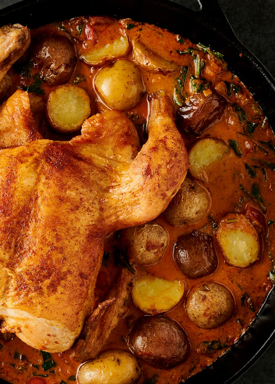 Bombay chicken and potatoes in a skillet - close up from above.