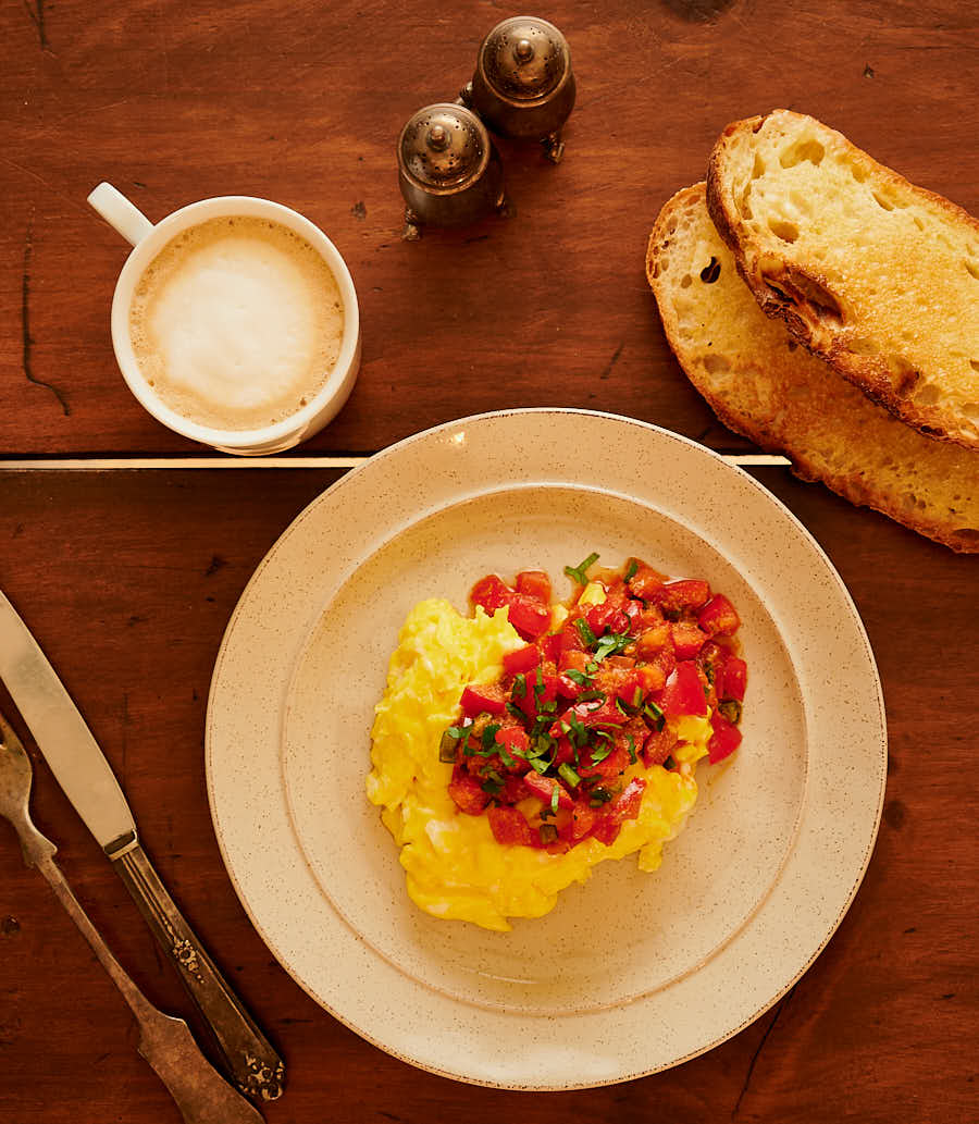 Table scene of ekoori, cappuccino, and sourdough toast.