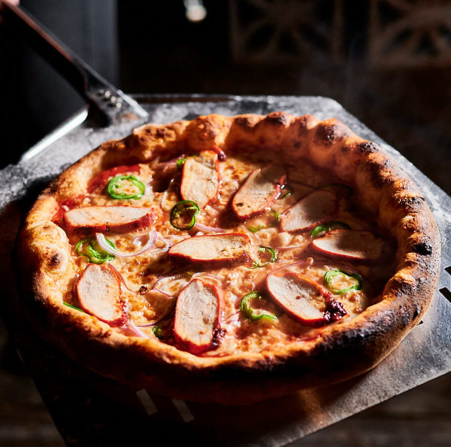 Tandoori pizza from the oven on a paddle