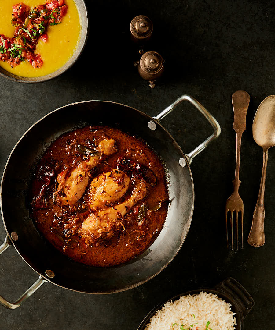 Chettinad chicken curry, dal and rice table scene from above
