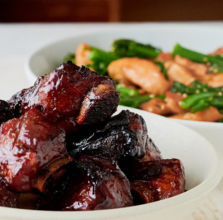 Bowl of char siu ribs from the front - table scene