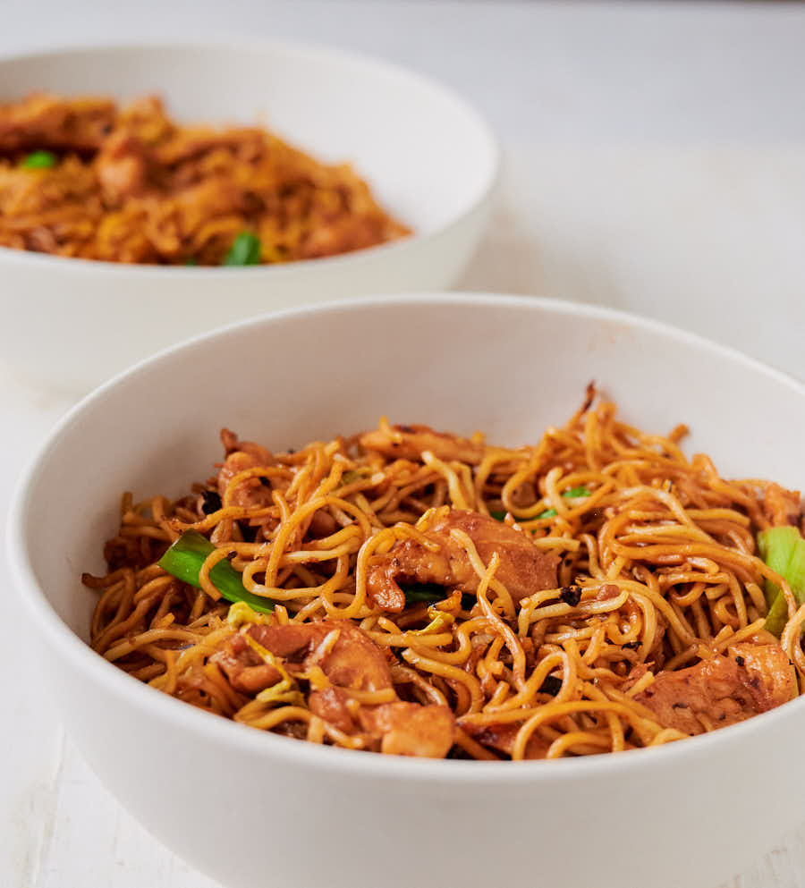 Two bowls of chicken chow mein with black beans from the front