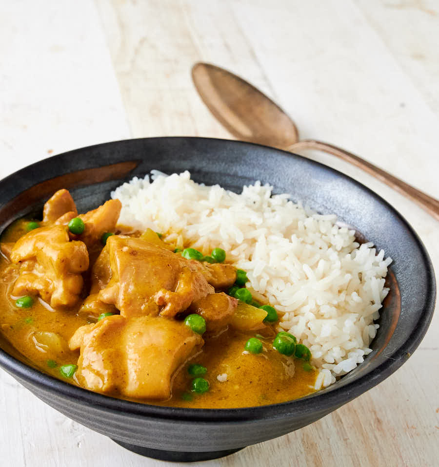 Chinese chicken curry and rice in a bowl from the front