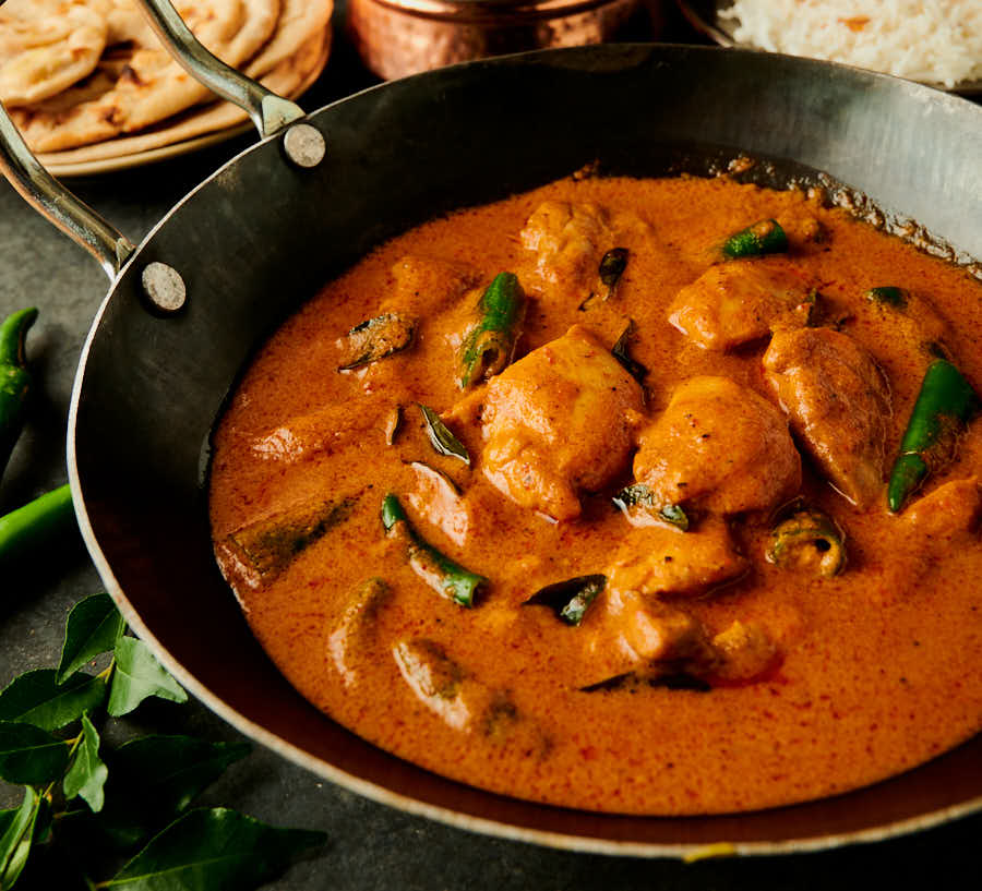 South Indian chicken curry in a kadai from the front.