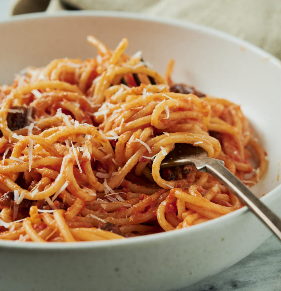 Bowl of spaghetti all'amatriciana with a fork