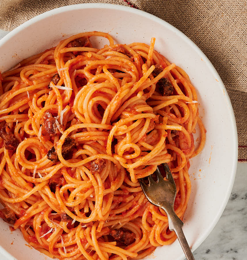 bowl of spaghetti all'amatriciana with fork from above