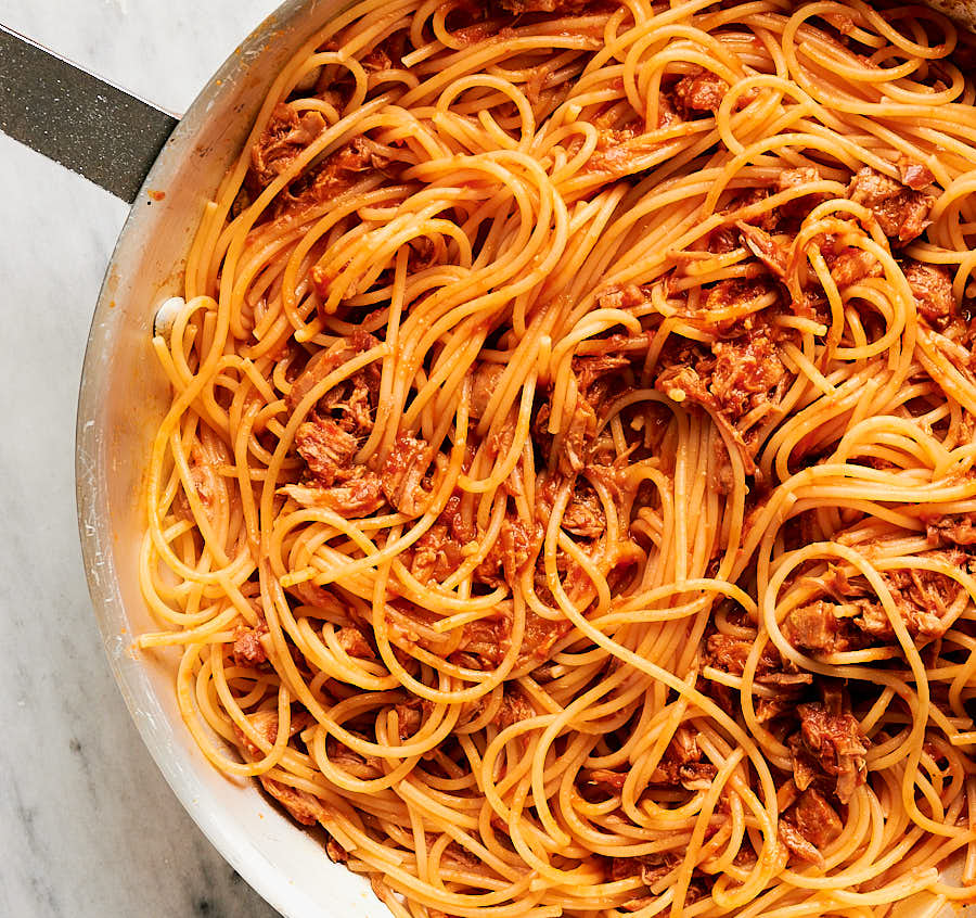 pork ragu and spaghetti in a skillet from above