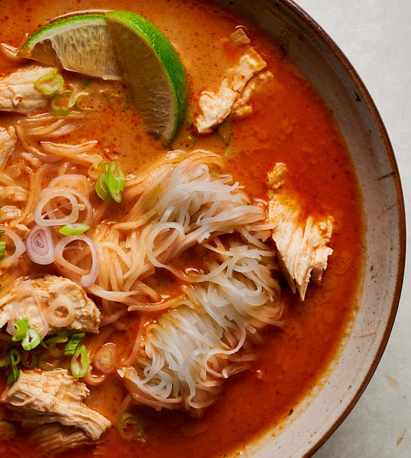 Closeup of noodles in tom kha gai coconut broth